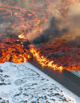 Lava crosses the main road to Grindavík and flows on the road leading to the Blue Lagoon in Grindavík, Iceland, Feb. 8, 2024. (AP Photo/Marco Di Marco)